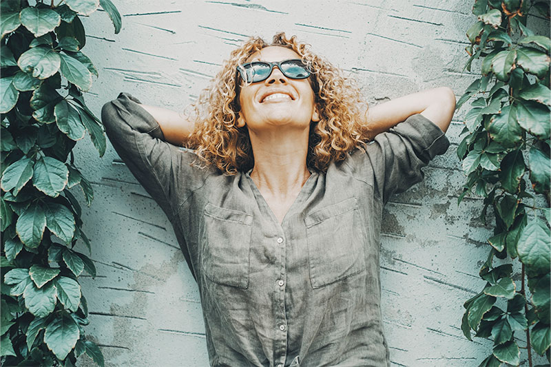 A woman relaxes as she practices caregiver stress relief strategies, strengthening emotional resilience for future challenges.